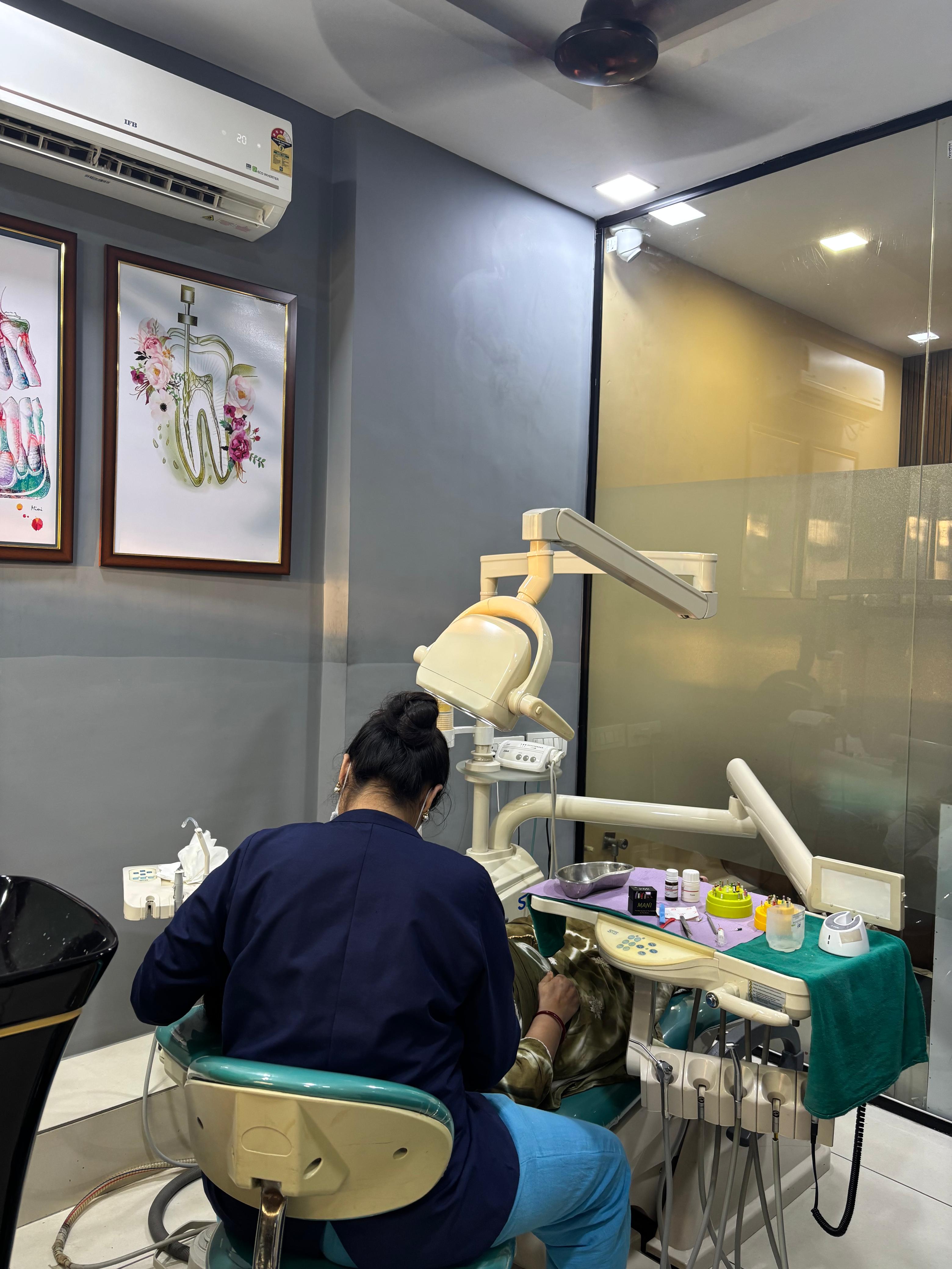 A dentist caring for a patient at Dentlux Studio